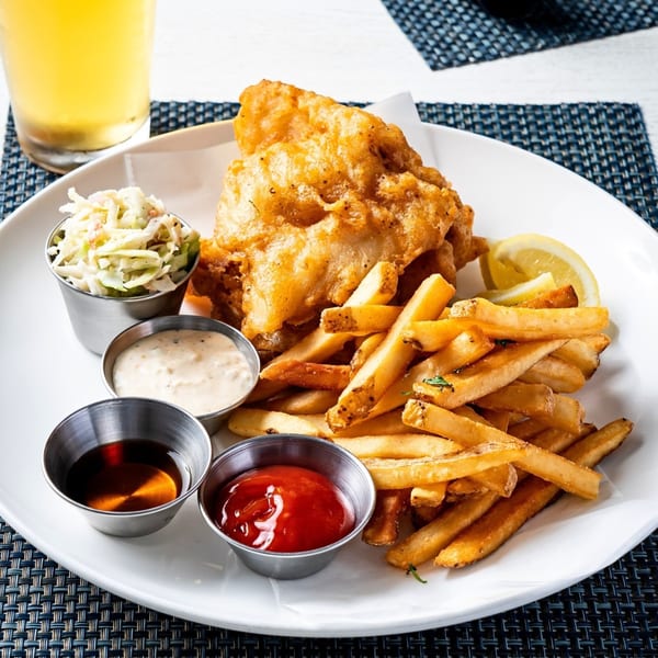 All Set's golden-fried fish and chips with coleslaw, tartar sauce, ketchup, and malt vinegar.
