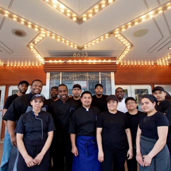 All Set Restaurant & Bar staff, a diverse group of men and women, smiling in front of the restaurant.