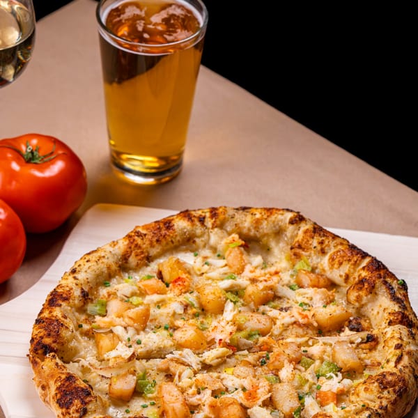 All Set Restaurant & Bar's seafood pizza with shrimp and crab, beer, and tomatoes.